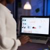 African American Businesswoman Holding Laptop Computer Typing Economic Company Profit - Auster Inteligência Contábil
